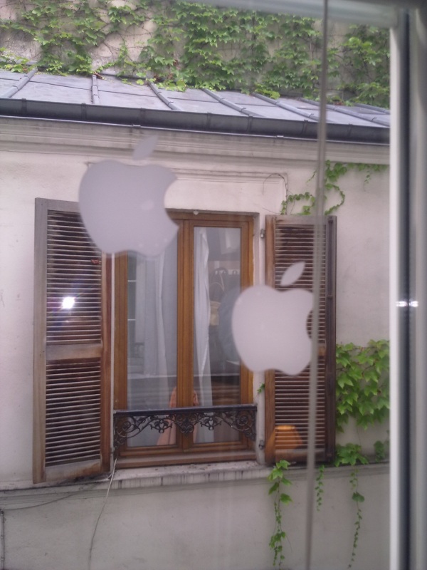 Apple stickers stuck to the window of an appartment.